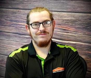 brunette male standing against fake fire backdrop