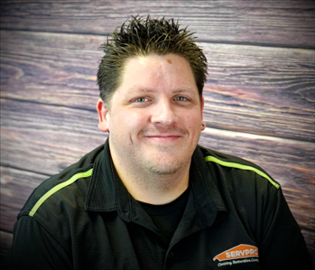 brunette male standing against fake fire backdrop