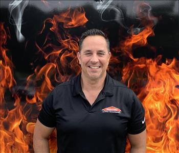 man smiling against faux fire backdrop