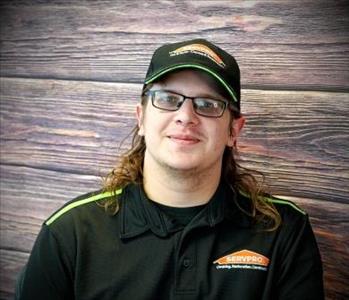 brunette male standing against fake fire backdrop