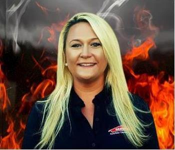 Dawn Walters, human resources director! Female, blonde hair, smiling against fake fire background. Has on SERVPRO attire. 